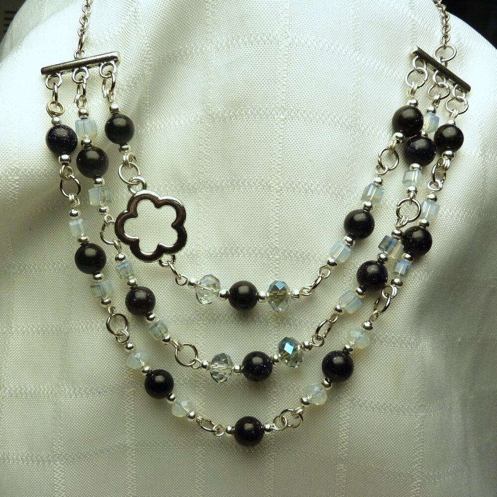 No534 Handmade necklace with several rows of glass beads and a pretty flower